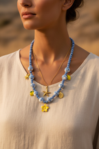 Blue and white beaded necklace with lemon charms on model